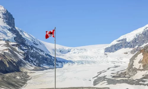 A-Canadian-Flag-on-a-pole-with-the-Athbasca-Glacier-in-the-background-as-seen-from-the-Columbia-Icefield-Glacier-Adventure.jpg